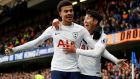 Tottenham’s Dele Alli celebrates scoring their second goal with Son Heung-min during the Premier League game against Chelsea at Stamford Bridge. Photograph:  Peter Nicholls/Reuters 