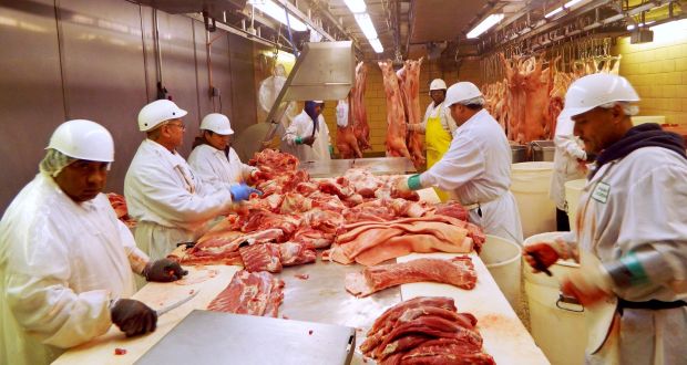 Workers cut pork at Park Packing in Chicago, Illinois: China slapped extra tariffs of up to 25 per cent on US frozen pork. Photograph: Reuters