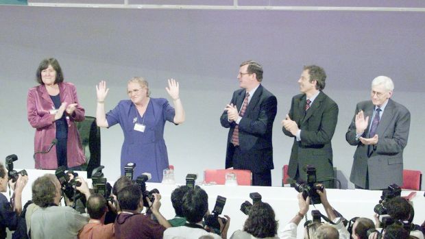 Mo Mowlam is congratulated by Deputy First Minister of the Northern Ireland Assembly Seamus Mallon, British prime minister Tony Blair, First Minister David Trimble, and British minister for overseas development Clare Short after her speech at the Labour Party conference. Photograph: Paul Hackett / Reuters