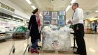 Aidan Whelan, manager at Nolan’s supermarket in Clontarf, and customer Irene Lavin from Clontarf, beside a giant display of waste plastic. Photograph: Alan Betson 