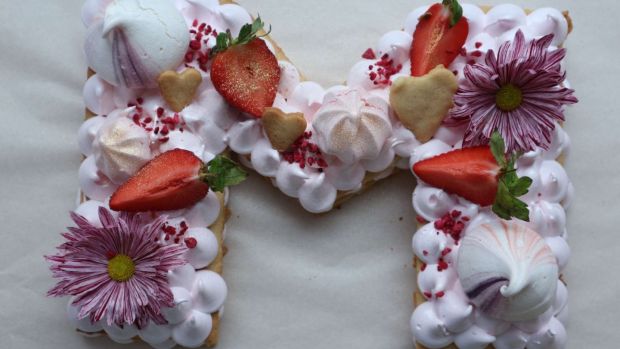 A shortbread celebration cake decorated with meringues, marshmallows, fruit and flowers from Delish Melish