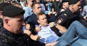 Putin opponent Alexei Navalny is carried away by police at a demonstration against the Russian president in Pushkin Square in Moscow, Russia. Photograph: AP Photo
