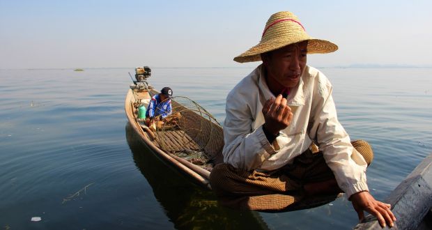 Myint Soe and his son use centuries-old methods to catch fish on Inle Lake. Photograph: Stephen Starr