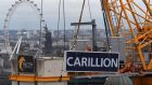 A Carillion sign is removed from a crane in London after the UK construction and outsourcing group announced its liquidation in January 2017. Photograph: Daniel Sorabji/AFP/Getty Images