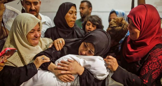 The mother of Layla Ghandour, a Palestinian baby of eight months who died during Monday’s violence in Gaza, holds her at the morgue of al-Shifa hospital in Gaza City on Tuesday. Photograph: Mahmud Hams/AFP/Getty Images