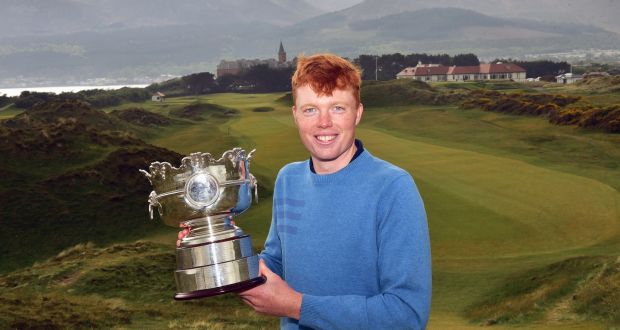 Tramore’s Robin Dawson with the Flogas Irish Amateur Open trophy at Royal County Down Golf Club. Photograph: Pat Csahman  