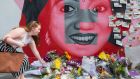 Floral tributes are laid  at a mural to Savita Halappanavar on  Camden Street in Dublin on Saturday. Photograph: Getty Images