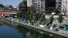 Tents where migrants live in a makeshift camp are packed alongside of the canal Saint-Martin in Paris on  May 18th. Photograph: Francois Mori/AP