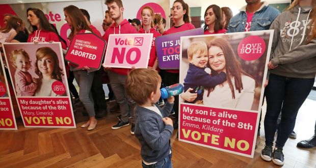 Two-year-old Rossa Maloney looks at his picture with his mother Emma in a Love Both rally in Dublin, ahead of the referendum on the Eighth Amendment  Photo: Niall Carson/PA Wire