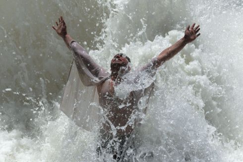 TEST THE WATERS: An Afghan man cools off on a hot summer day as temperatures reach 42 degrees on the outskirts of Jalalabad. Photograph: Noorullah Shirzada/AFP/Getty Images
