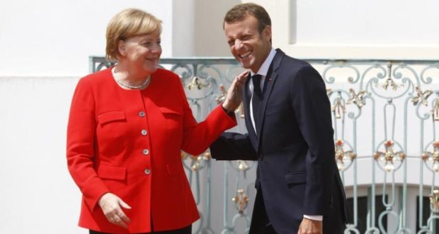 German chancellor Angela Merkel greets French president Emmanuel Macron on Tuesday during German-French government consultations near Gransee in Germany. Photograph: Michele Tantussi/Getty Images