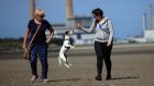 Judy and Kim Doran, from Crumlin, with Nugget, a rescue dog from the DSPCA, enjoy the warm weather on Sandymount Strand. Photograph:  Garrett White 
