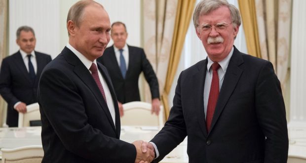 Russian president Vladimir Putin shakes hands with US national security adviser John Bolton during their meeting in the Kremlin in Moscow, Russia, on Wednesday. Photograph: AP Photo/Alexander Zemlianichenko, Pool