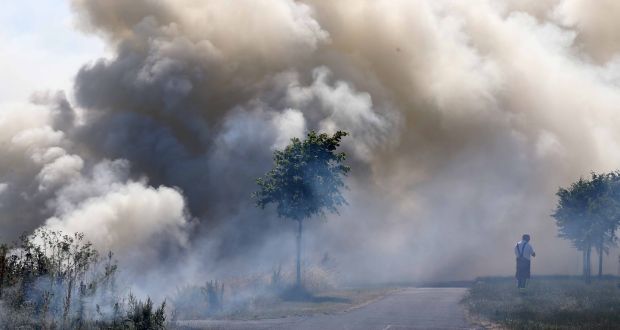  Firemen attend gorse fires at the Tolka Valley estate in Finglas on Thursday as temperatures in Dublin hit 24 degrees. Photograph: Sam Boal/Rollingnews.ie