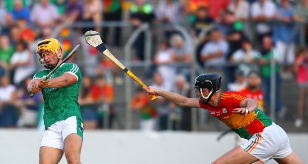  Limerick’s Tom Morrissey shoots under pressure from Carlow’s Ross Smithers. Photograph: Ken Sutton/Inpho