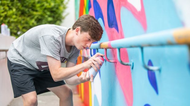 Lee Prendiville works on the Clay Youth Project mural. Photograph: Naoise Culhane