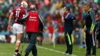 Clare’s managers Gerry O’Connor and Donal Moloney look on as Galway’s Joe Canning leaves the field the injured. Photograph: James Crombie/Inpho