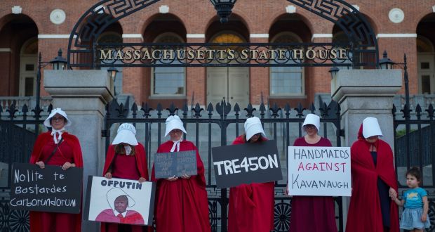  Women dressed in Handmaids cloaks and hoods, hold signs in protest of United States President Donald J. Trump while standing in front of the Massachusetts State House in Boston, Massachusetts.  Some 35 per cent of rich young Americans  believed that it would be a ‘good’ thing for the army to take over EPA/CJ GUNTHER