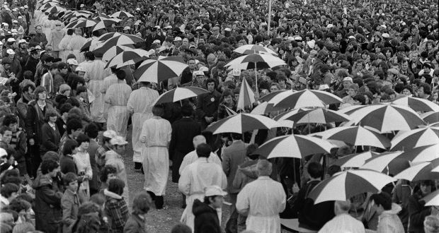 Pope John Paul II’s visit to Ballybrit Racecourse in Galway in 1979. Escorts hold umbrellas over the priests who are administering Holy Communion.