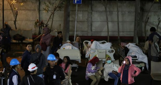  Hospital patients await treatment outside  after an earthquake hit Lombok, West Nusa Tenggara, Indonesia, on Sunday. Photograph: EPA