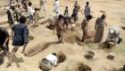 Yemenis dig graves for the victims of a Saudi-led air strike on Thursday that hit a bus carrying children. Photograph: EPA
