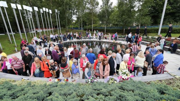 People visiting the Omagh memorial garden after attending the ceremony for victims of the car bomb on Market Street on the 15th August 1998, the worst single atrocity of the Northern Ireland conflict which killed 29 people, including a woman pregnant with twins. Photograph: Niall Carson/PA