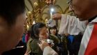 A Chinese Catholic is baptised during at the Cathedral of the Immaculate Conception in Beijing. The total number of Catholics in China is estimated at between 12 million and 30 million. Photograph: Mark Ralston/AFP/Getty Images