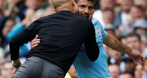 Manchester City manager Pep Guardiola congratulates  Sergio Aguero as he leaves the pitch substituted after completing his hat-trick against Huddersfield Town. Photograph: Darren Staples/Reuters 