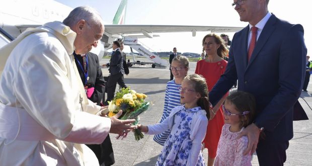   Pope Francis  receiving a bouquet of flowers from a daughter of  Minister for  Foreign Affairs  Simon Coveney  at Dublin airport. Photograph: EPA 