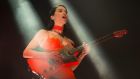St Vincent: imperious in orange PVC, Annie Clark manipulates a selection of primary-colour guitars with demonic zest. Photograph: Dave Meehan
