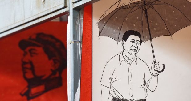 Posters of late communist leader Mao Zedong and President Xi Jinping  at a market in Beijing:  next step is to bring the China Dream overseas. Photograph: Greg Baker/AFP/Getty 