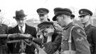 Minister for Defence Oscar Traynor, chief of staff Maj Gen Liam Egan (far left), inspecting recruits at Portobello Barracks, Dublin. Cpl Patrick Kavanagh instructs Pvt John Belmont in sighting a rifle. On the far right is Lt Col P Kierse. Photograph: Dermot Barry