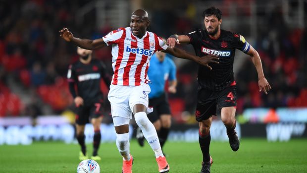 Benik Afobe of Stoke City – sponsored by Bet365 – holds off Jason Lowe of Bolton Wanderers – sponsored by BetFred – during the recent Sky Bet Championship match at the Bet365 Stadium. Photo: Nathan Stirk/Getty Images