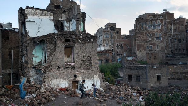 Boys play in the rubble of a home destroyed in an air strike on the Old City of Sanaa, Yemen. Photograph: Tyler Hicks/The New York Times