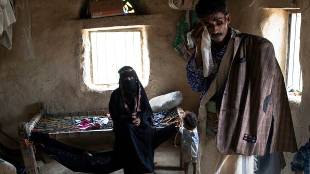 Ali al-Hajaji and his wife, Mohamediah Mohammed, with their son Shakir (1) at their home in Juberia, Yemen. Photograph: Tyler Hicks/The New York Times