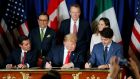 US president Donald Trump (centre), Mexico’s president Enrique Pena Nieto (left) and Canada’s prime minister Justin Trudeau sign the new deal in  Buenos Aires on Friday. Photograph: Reuters 