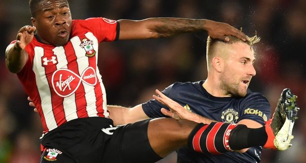 Southampton’s Irish  striker Michael Obafemi  tangles with Manchester United’s  Luke Shaw. Photograph: Getty Images