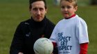 All Star Colm Cavanagh of Tyrone with five-year-old Dylan O’Kane during a coaching session at Philadelphia GAA Club during the PwC All Stars Football tour. Photograph: Ray McManus/Sportsfile 