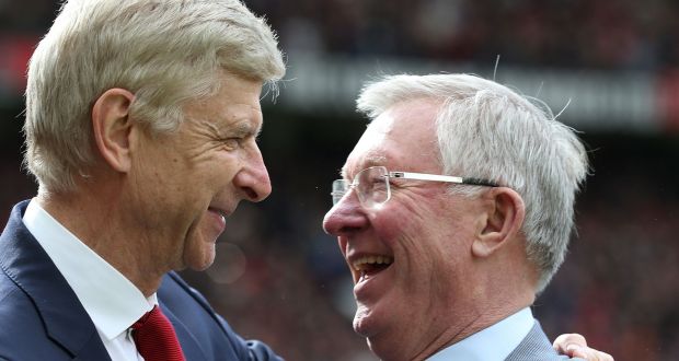 Former Manchester United manager Alex Ferguson presents Arsenal manager Arsene Wenger with a gift to mark his retirement in April 2018. Photograph: Stuart MacFarlane/Arsenal 