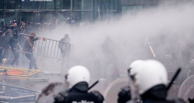Protestors face off against the police during an anti-migrant demonstration outside of EU headquarters in Brussels. Photograph: AP