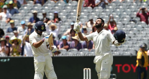 India’s  Cheteshwar Pujara  celebrates his century with team-mate Virat Kohli applauding on day two of the third Test at the Melbourne Cricket Ground. Photograph: Hamish Blair/EPA