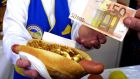 A customer pays for a hot dog in Frankfurt at the start of  2002. The euro’s introduction is remembered as an unsentimental quid pro quo. Photograph: AP/Wolfram Steinberg