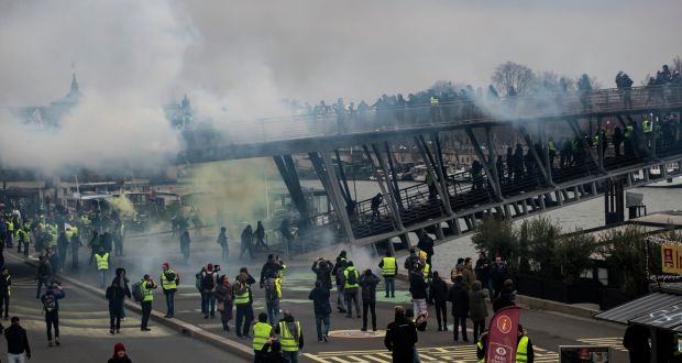 Protesters try to cross a bridge over the Seine river during a ‘yellow vests’ protest in Paris, France. Photograph: Ian Langsdon/EPA