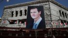 A banner depicting Syrian president Bashar al-Assad in Douma: Unless Syria recovers, millions of Syrian refugees will stay in host countries. Photograph: Marko Djurica