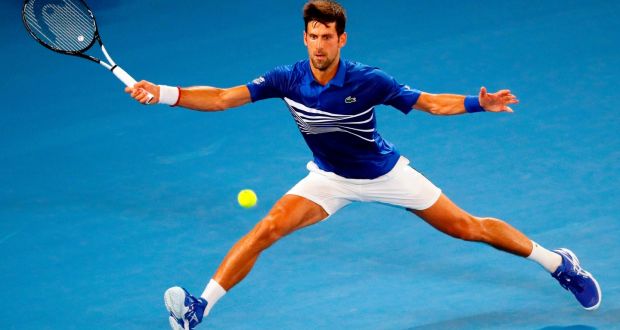 Serbia’s Novak Djokovic hits a return against France’s Jo-Wilfried Tsonga during their men’s singles match on day four of the Australian Open  in Melbourne. Photograph:  David Gray/AFP/Getty Images