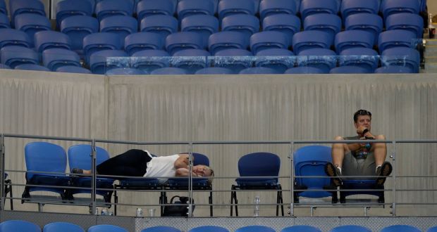 A spectator sleeps at Margaret Court Arena as s Garbine Muguruza and  Johanna Konta played their  second round match until after 3am at the Australian Open tennis championships in Melbourne. Photograph: Mark Baker/AP 