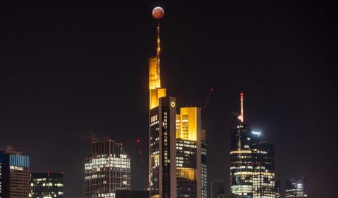 A Super Blood Moon is above the Frankfurt skyline during a lunar eclipse. Photograph: Frank Rumpenhorst/AFP