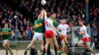 Kerry’s Paul Murphy and Jack Barry challenge Tyrone’s Cathal McShane in the air. Photograph: Ryan Byrne/Inpho