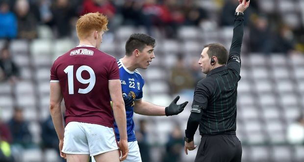 Referee Derek O’Mahoney shows a black card to Galway’s Peter Cooke and Killian Brady of Cavan during the Allianz Football League Division 1 match at  Pearse Stadium, Galway on Sunday. Photograph: Tommy Grealy/Inpho