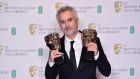 Director Alfonso Cuaron with the awards for director and for best film for ‘Roma’ at the 2019. Ben Stansall/AFP/Getty Images